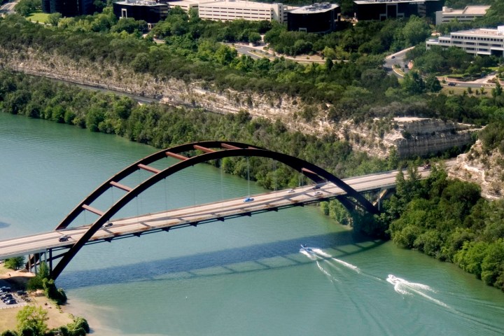 a train traveling over a bridge over a body of water